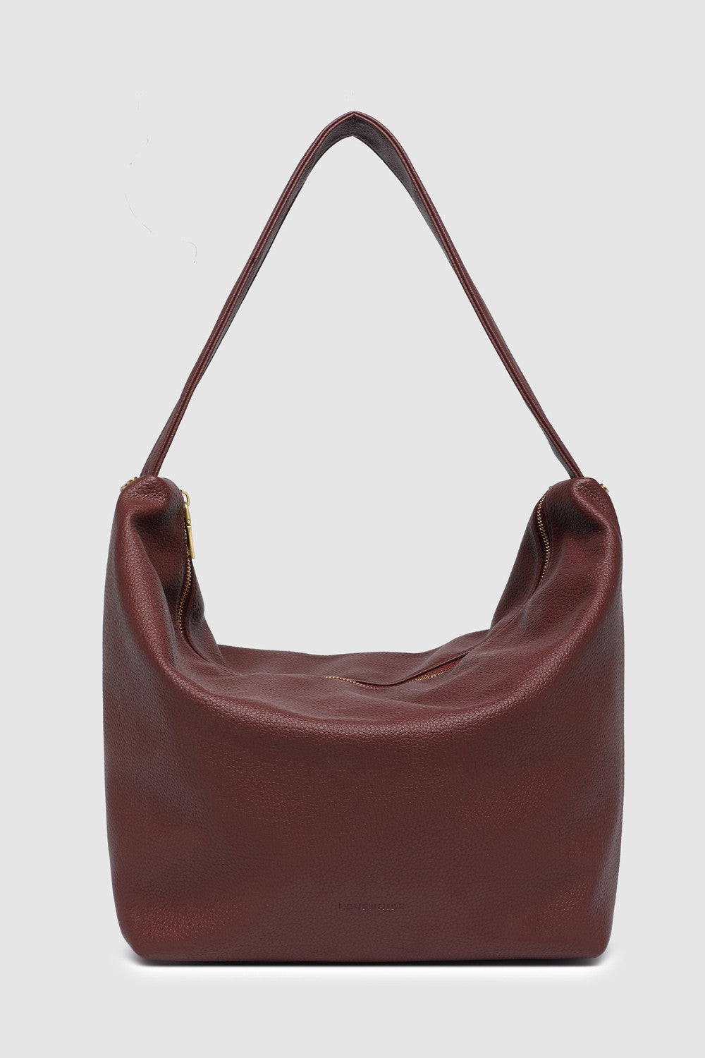 Burgundy pleather handbag on a light gray background