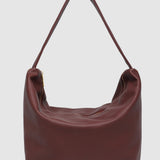Burgundy pleather handbag on a light gray background