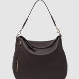 Brown handbag with a strap on a light gray background