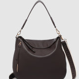 Brown handbag with a shoulder strap on a light gray background
