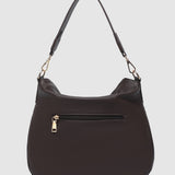 Brown handbag with a gold zipper on a light gray background