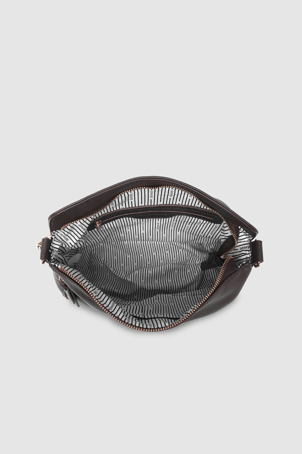 Brown handbag with a striped lining on a light gray background