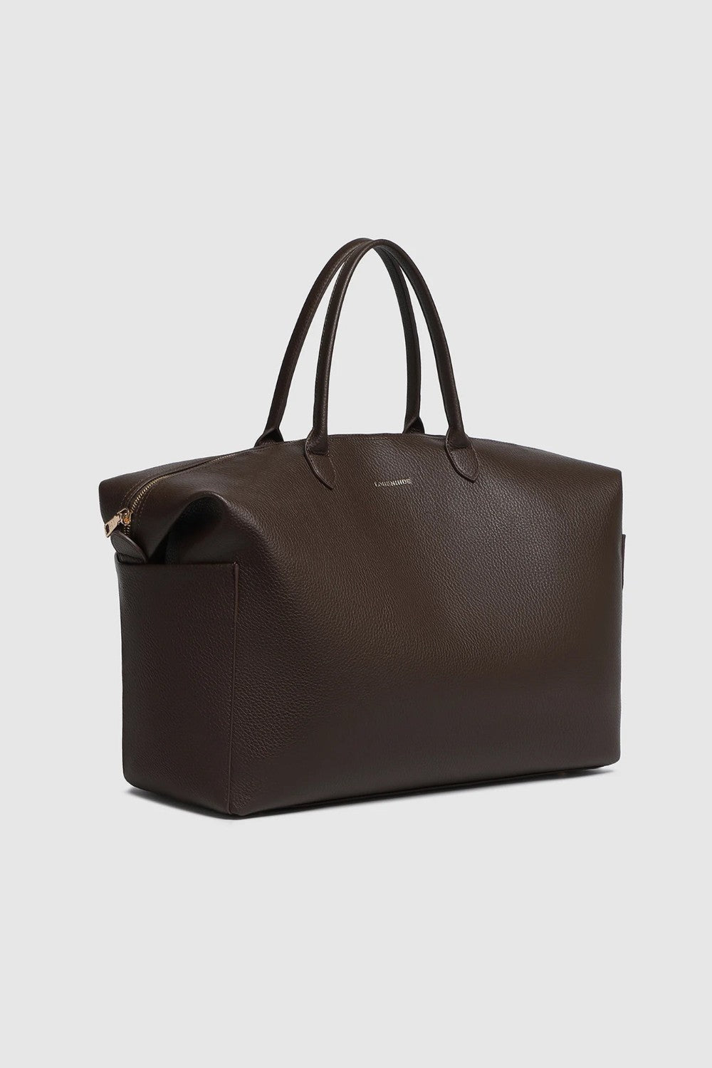 A large brown pebbled leather duffel bag with handles on a light background.