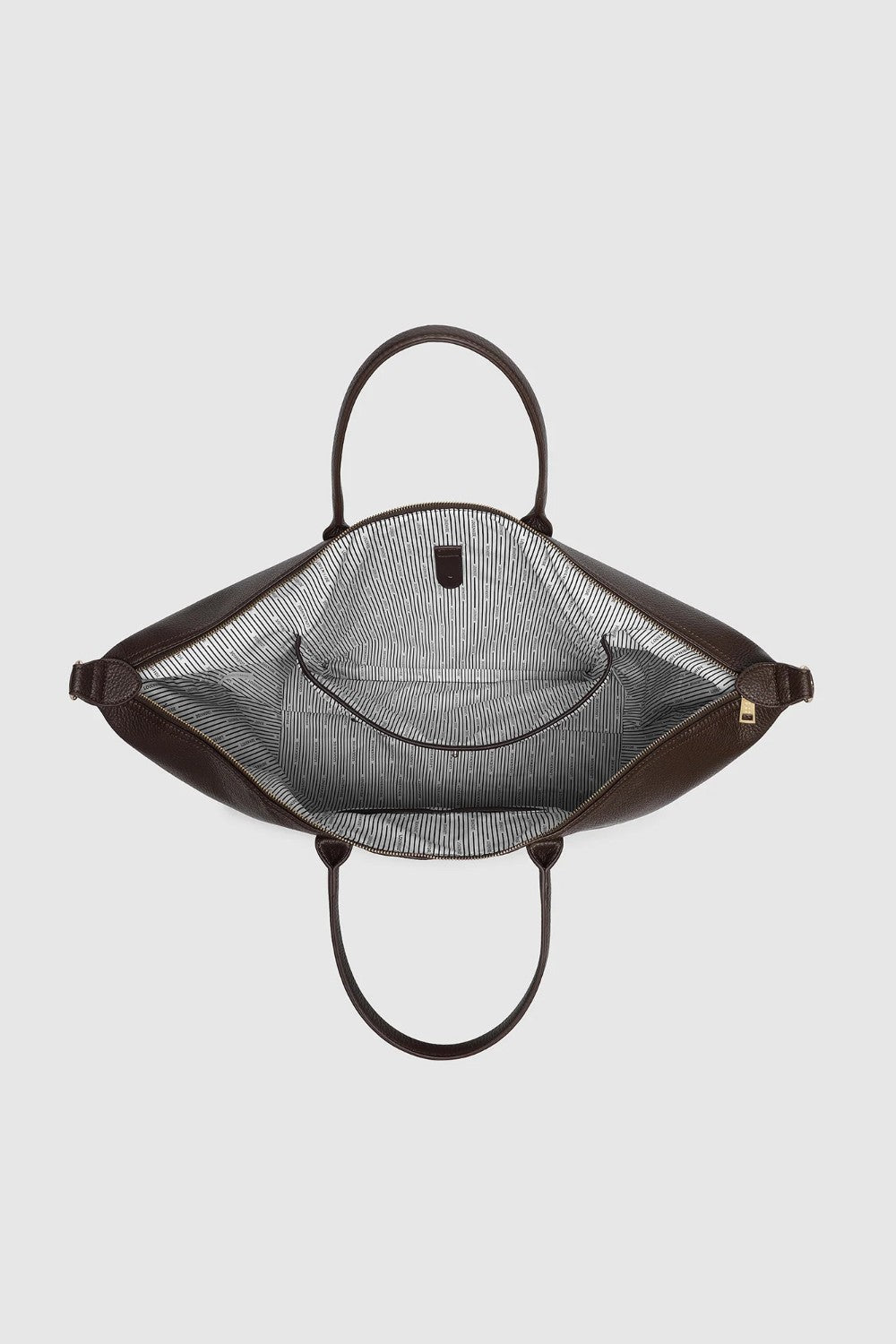 Looking down into a large brown bag with a zipper closure, interior pocket, and black and white striped lining.
