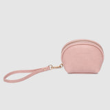 Pink coin purse with a strap on a light gray background