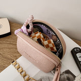 Pink handbag with accessories on a magazine