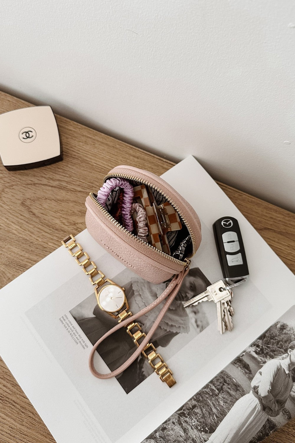 Pink pouch with keys on a magazine