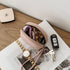 Pink pouch with keys on a magazine