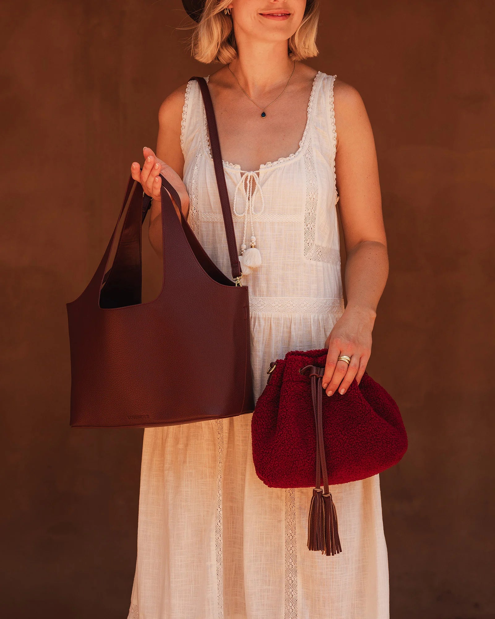 The Louenhide Paisley Handbag is unapologetically bold, textural, and designed to elevate your look with zero effort. Throw it over your arm or wear the internal faux shearling bucket bag for a more relaxed finish - either way, the Paisley is here to play. Worn together or styled separately, the pairing creates an unexpected contrast that brings warmth and softness to structured winter layering. Whether you're styling it back with leather, denim or sweeping silhouettes, the Paisley Handbag easily earns its 