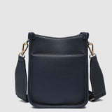 Navy pleather crossbody bag on a light gray background
