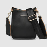 A black pebbled leather crossbody bag with gold-tone hardware, and a wide adjustable shoulder strap printed with 'LOUENHIDE' and a star. The brand name 'LOUENHIDE' is embossed on the front.