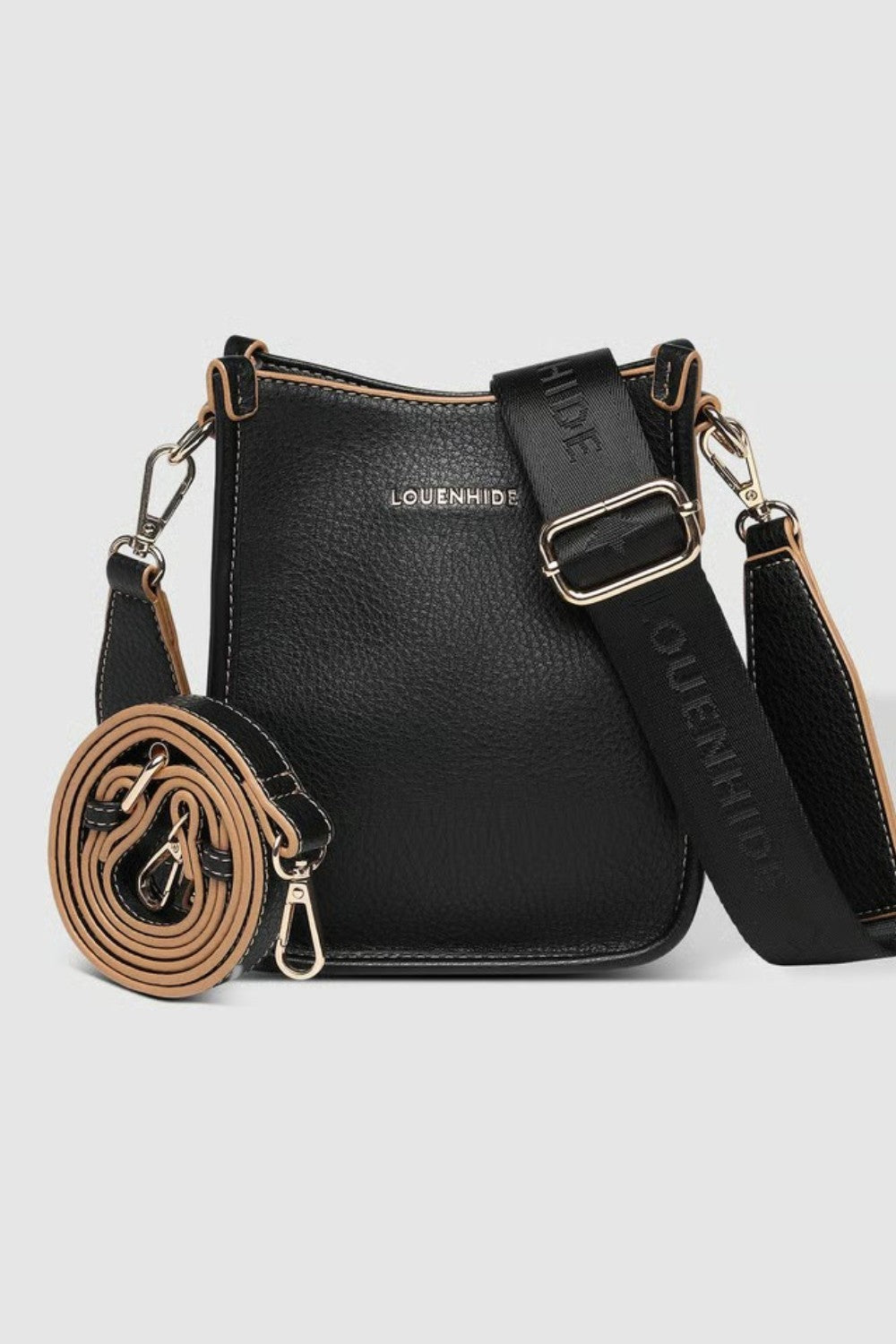 A black pebbled leather crossbody bag with a matching rolled-up strap, gold-tone hardware, and a wide adjustable shoulder strap printed with 'LOUENHIDE' and a star. The brand name 'LOUENHIDE' is embossed on the front.