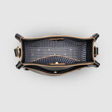 Looking down into a black bag with a black and white striped lining.