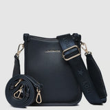 A navy pebbled leather crossbody bag with a matching rolled-up strap, gold-tone hardware, and a wide adjustable shoulder strap printed with 'LOUENHIDE' and a star. The brand name 'LOUENHIDE' is embossed on the front.