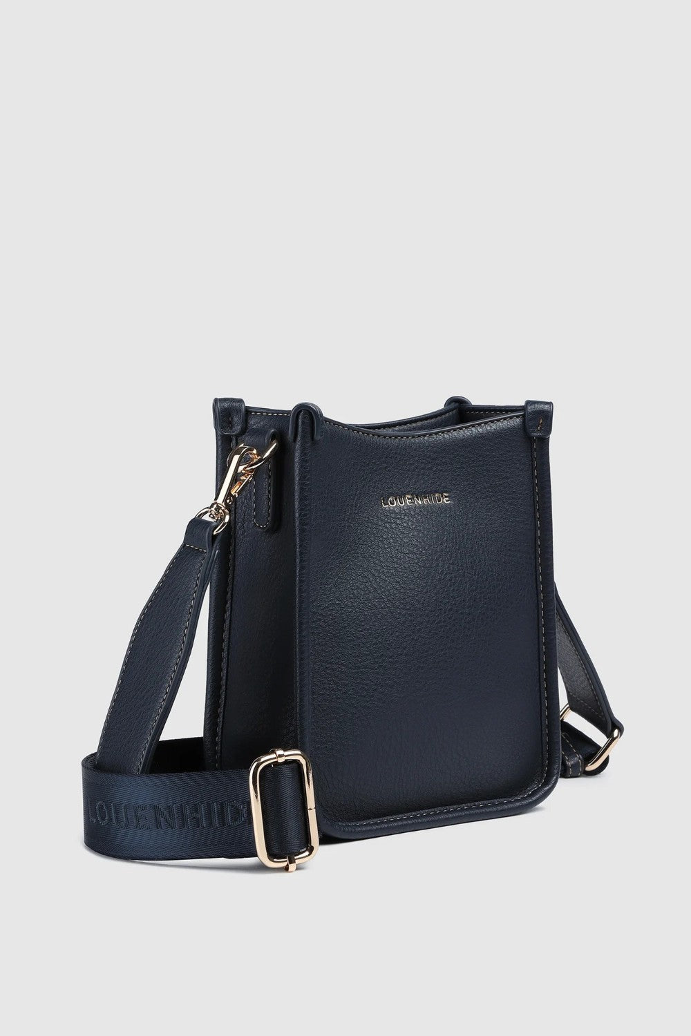 A navy pebbled leather crossbody bag with gold-tone hardware, and a wide adjustable shoulder strap printed with 'LOUENHIDE' and a star. The brand name 'LOUENHIDE' is embossed on the front.
