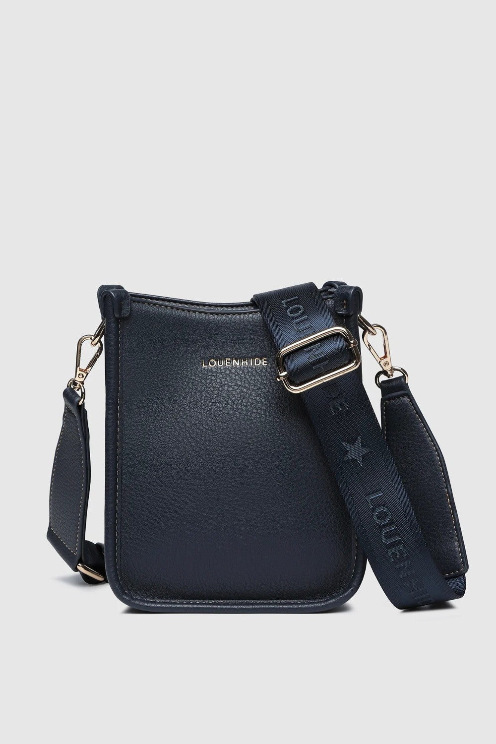 A navy pebbled leather crossbody bag with gold-tone hardware, and a wide adjustable shoulder strap printed with 'LOUENHIDE' and a star. The brand name 'LOUENHIDE' is embossed on the front.