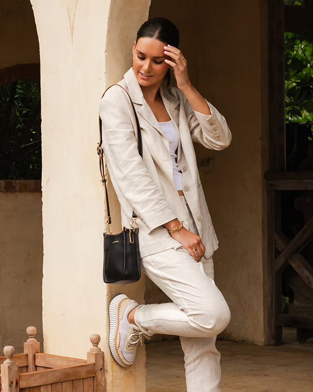 The Louenhide Parker Phone Crossbody Bag effortlessly combines an elevated aesthetic with everyday functionality. Whether you're heading to the office, running errands or meeting friends for coffee, this minimalistic phone bag will be your new go-to. Parker features an on-trend and modern silhouette, enhanced by the contrasting stitch details in two classic colourways. Elevate your style with the sateen webbing guitar strap or keep it simple with the matching vegan leather crossbody strap. Keeping your esse