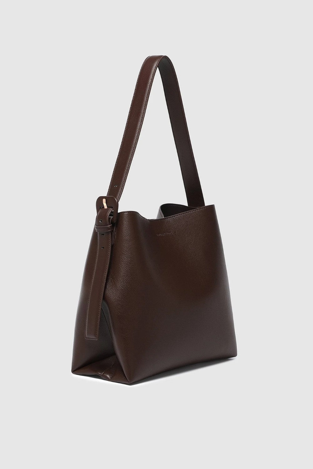 A dark brown leather hobo shoulder bag with a single strap and a subtle embossed logo on the front, shown against a light gray background.