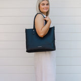 The Louenhide Portsea Tote Bag is a relaxed silhouette that is perfect for everyday wear. This versatile design also doubles as a casual work bag that adds a pop of fun to your corporate looks. Soft yet structured, this bag is perfect for women on-the-go. Featuring a luxurious suedette lining, vegan leather exterior with light gold hardware detailing, this shoulder bag is spacious and functional with enough room to carry all your essentials and more!