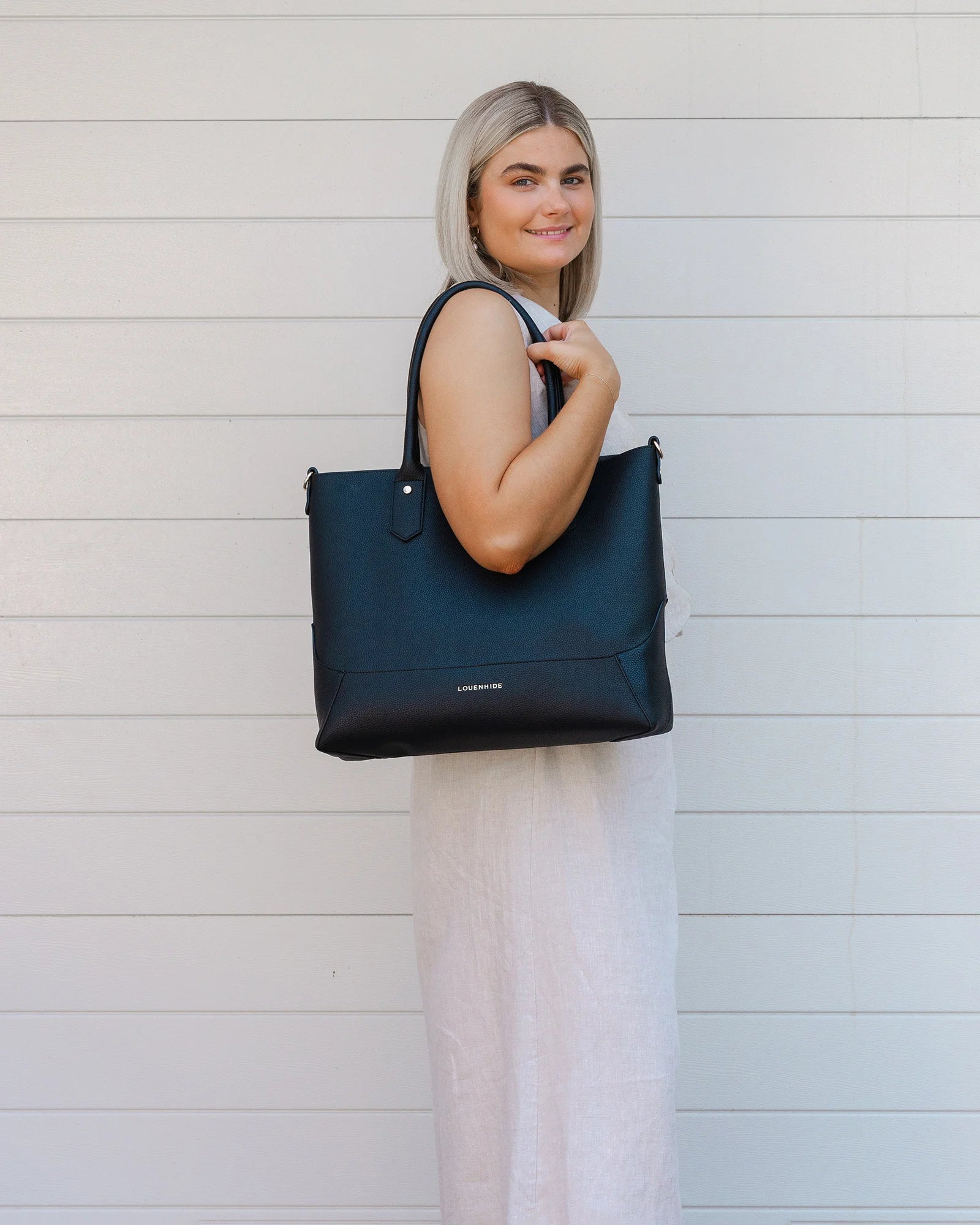 The Louenhide Portsea Tote Bag is a relaxed silhouette that is perfect for everyday wear. This versatile design also doubles as a casual work bag that adds a pop of fun to your corporate looks. Soft yet structured, this bag is perfect for women on-the-go. Featuring a luxurious suedette lining, vegan leather exterior with light gold hardware detailing, this shoulder bag is spacious and functional with enough room to carry all your essentials and more!