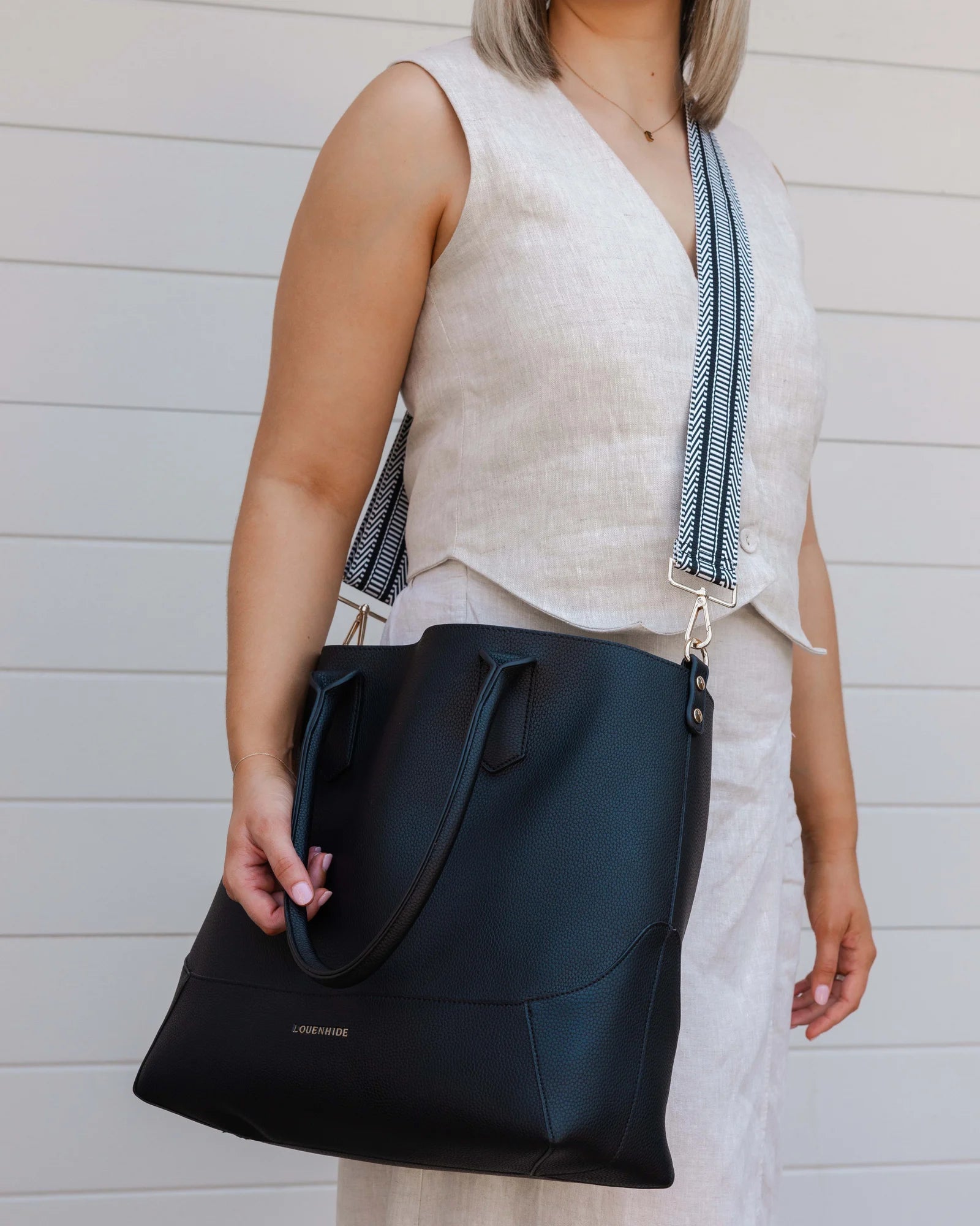 The Louenhide Portsea Tote Bag is a relaxed silhouette that is perfect for everyday wear. This versatile design also doubles as a casual work bag that adds a pop of fun to your corporate looks. Soft yet structured, this bag is perfect for women on-the-go. Featuring a luxurious suedette lining, vegan leather exterior with light gold hardware detailing, this shoulder bag is spacious and functional with enough room to carry all your essentials and more!