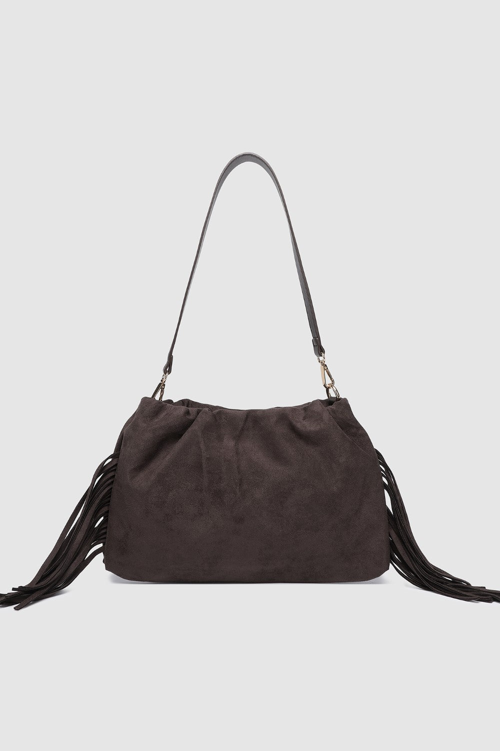 Brown suede handbag with fringes on a light gray background