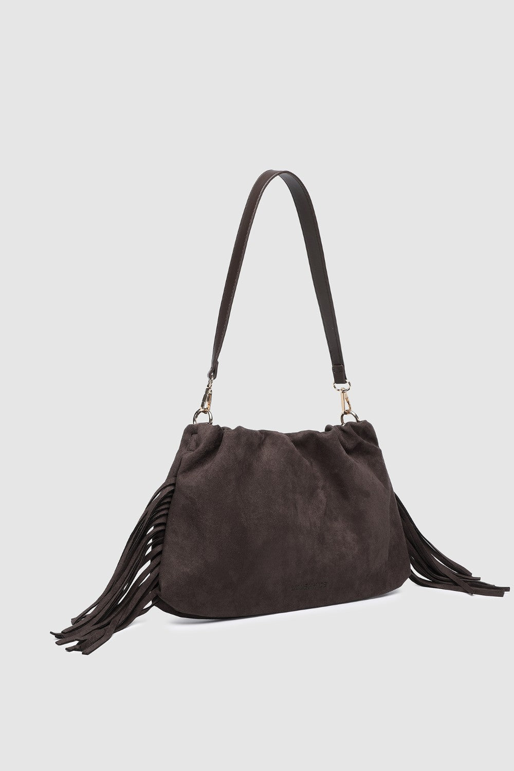 Brown suede handbag with fringes on a light gray background