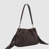 Brown suede handbag with fringes on a light gray background