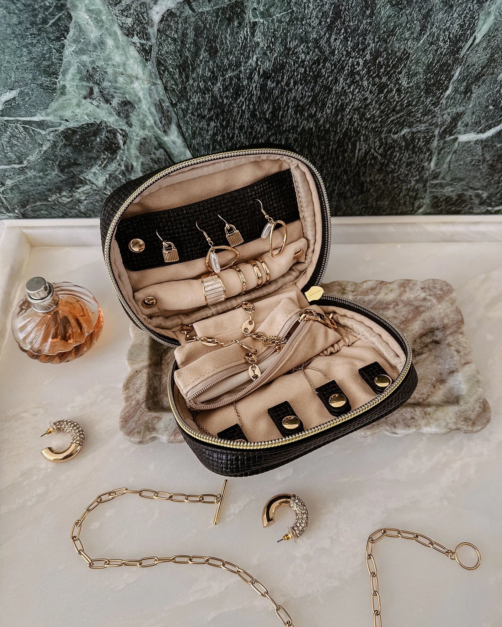 The Louenhide Rita Jewelry Case is the ideal travel accessory you didn't know you needed. Perfectly sized for travel, this women's jewellery case is a must-have for keeping your jewellery organized and protected on the go. Its sleek design fits effortlessly into your luggage or carry-on, while ensuring your accessories are always secure, organised and ready to shine. Say goodbye to tangled necklaces and lost earrings. With the ultimate internal organisation, there's a spot for everything. Whether you're jet