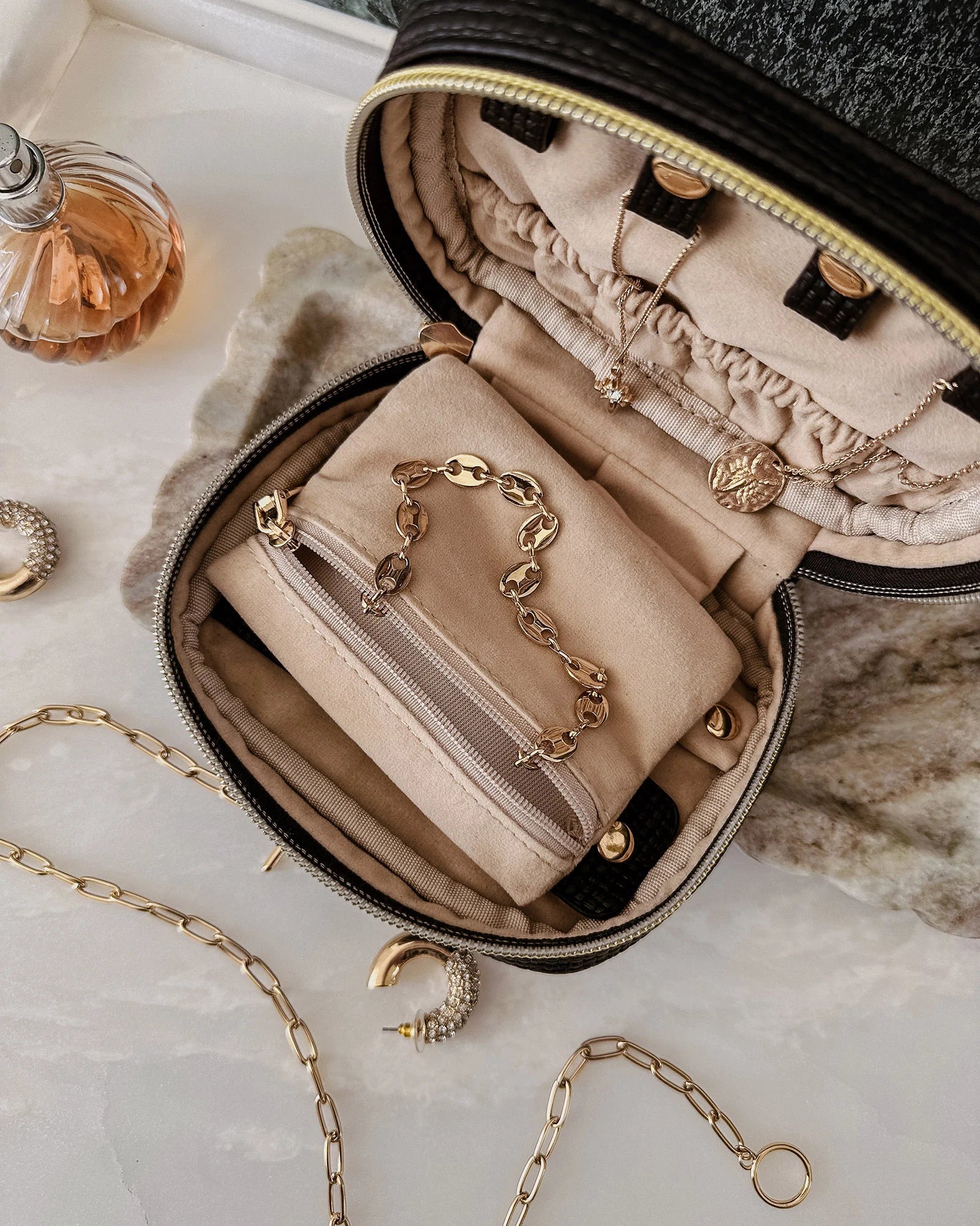 The Louenhide Rita Jewelry Case is the ideal travel accessory you didn't know you needed. Perfectly sized for travel, this women's jewellery case is a must-have for keeping your jewellery organized and protected on the go. Its sleek design fits effortlessly into your luggage or carry-on, while ensuring your accessories are always secure, organised and ready to shine. Say goodbye to tangled necklaces and lost earrings. With the ultimate internal organisation, there's a spot for everything. Whether you're jet