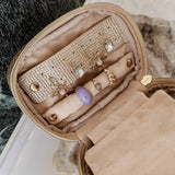 Open champagne coloured jewellery case on vanity setting background