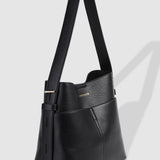 Black handbag with a visible brand logo on a light gray background