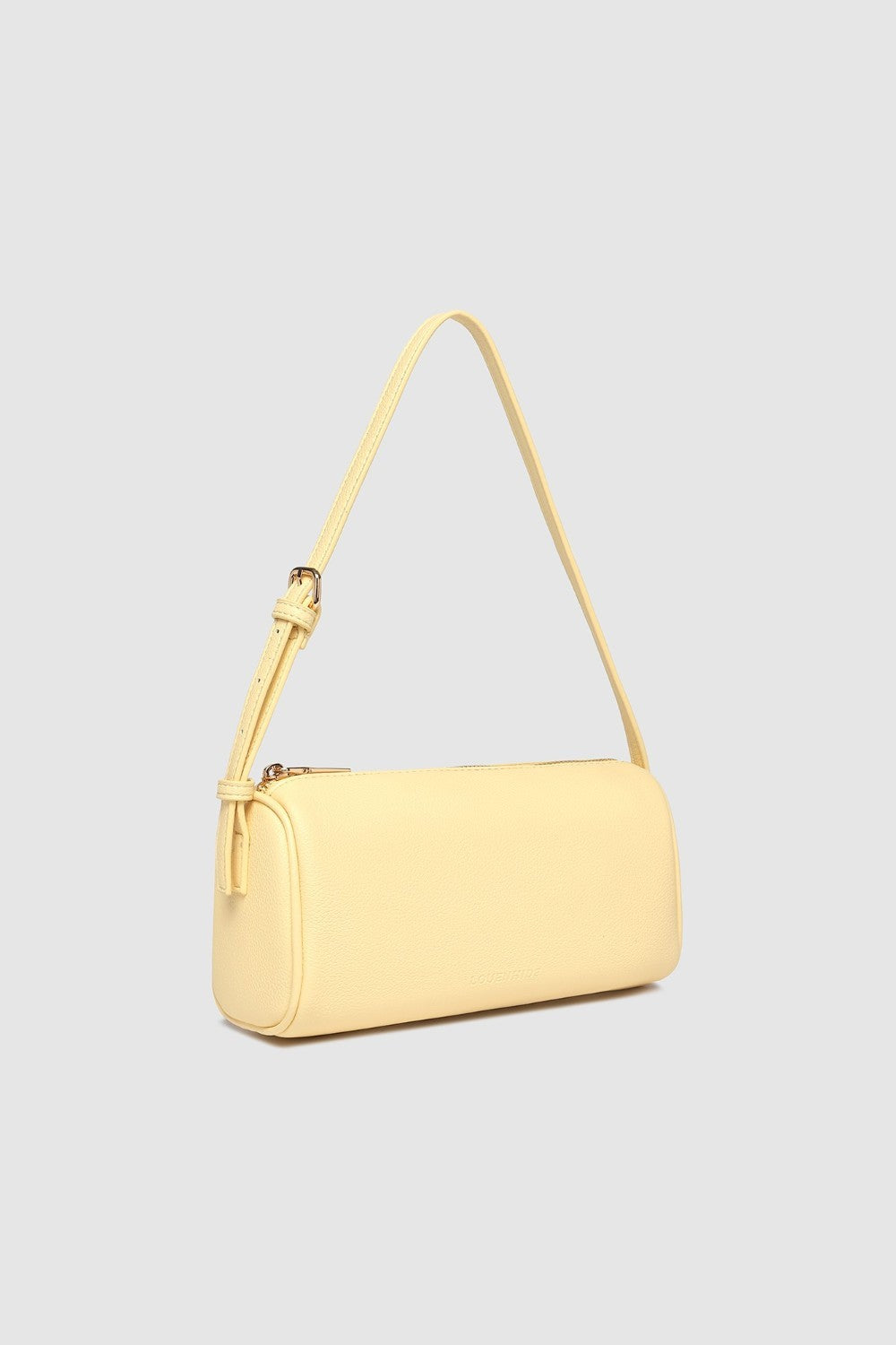 Yellow handbag with a strap on a light gray background