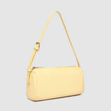 Yellow handbag with a strap on a light gray background