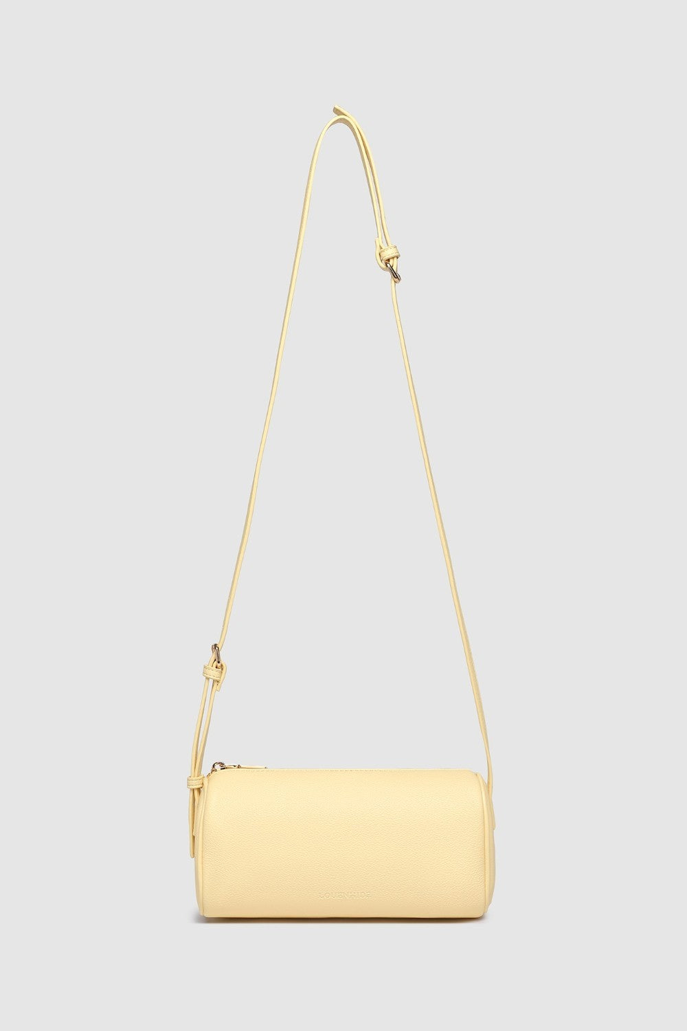 Yellow handbag with a strap on a light gray background