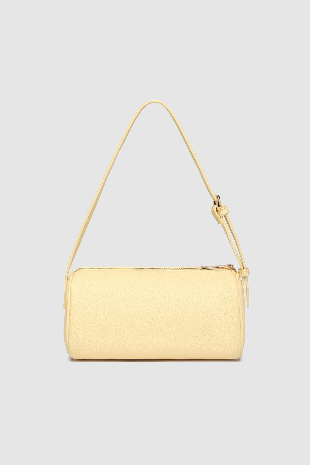 Yellow handbag with a strap on a light gray background