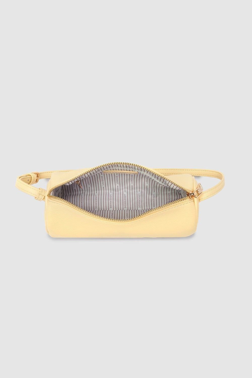 Yellow purse with striped lining on a light gray background
