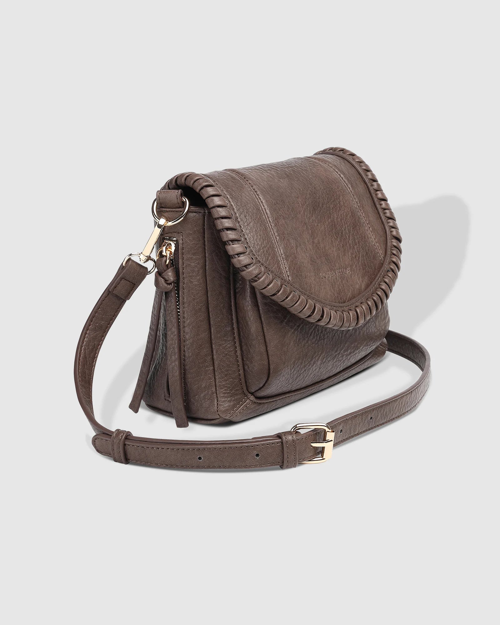 The Louenhide Shania Crossbody Bag is the epitome of elevated style that complements any ensemble. This casual women’s crossbody bag features a subtle woven vegan leather trim that adds a touch of effortless sophistication to your capsule wardrobe. 