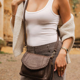 The Louenhide Shania Crossbody Bag is the epitome of elevated style that complements any ensemble. This casual women’s crossbody bag features a subtle woven vegan leather trim that adds a touch of effortless sophistication to your capsule wardrobe. 