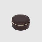 A small round dark brown leather jewelry box with a gold zipper, on a white background.