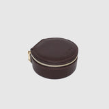 A small round dark brown leather jewelry box with a gold zipper, on a white background.