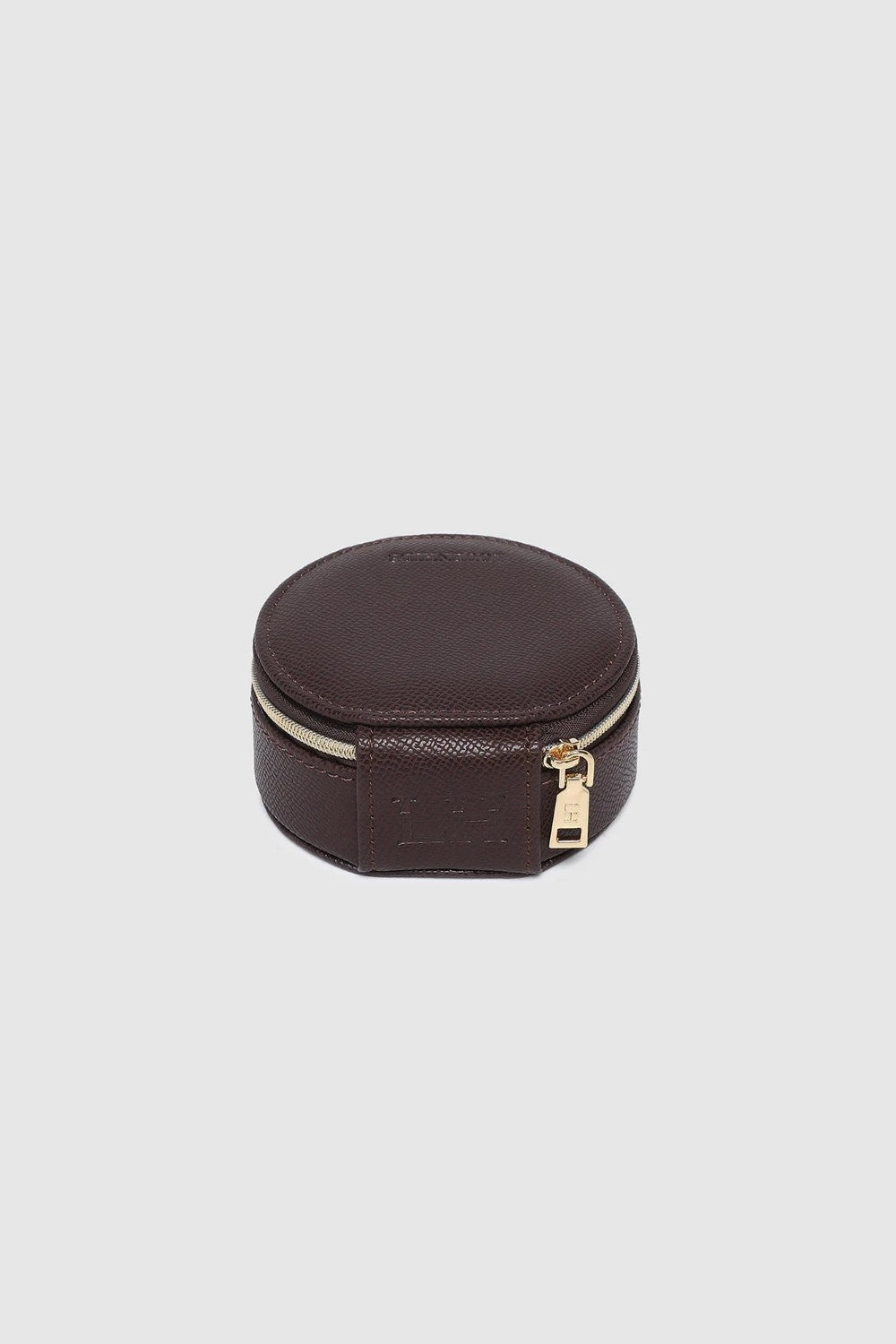 A small round dark brown leather jewelry box with a gold zipper, on a white background.