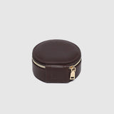 A small round dark brown leather jewelry box with a gold zipper, on a white background.
