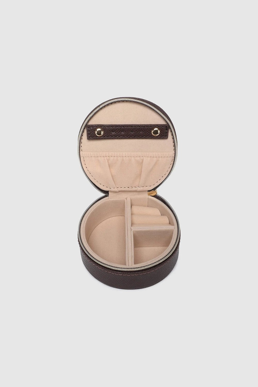 A small round dark brown leather jewelry box with a gold zipper, open to show interior, on a white background.