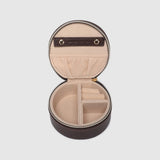 A small round dark brown leather jewelry box with a gold zipper, open to show interior, on a white background.