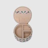 A round zippered jewelry organizer case with a green, pink, and white pattern on a white background.