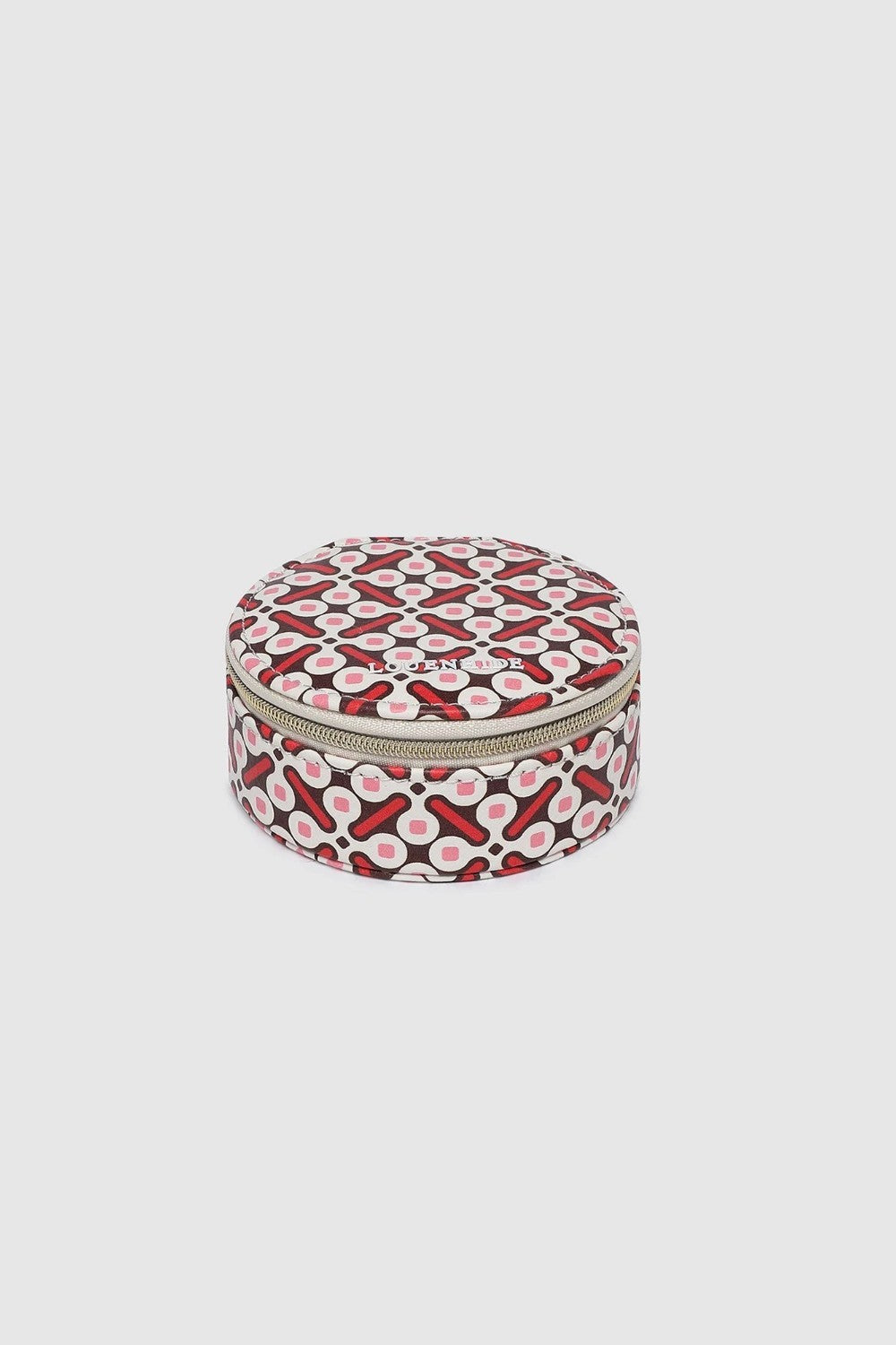 A round zippered jewellery case with a red, black, and white geometric pattern, shown against a solid light gray background.
