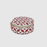 A small round zippered case with a red, white, and black geometric pattern, featuring a gold-tone zipper pull, shown on a light gray background.