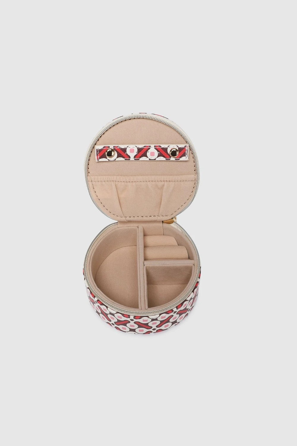 A round zippered jewellery case with a red, black, and white geometric pattern, shown against a solid light gray background.