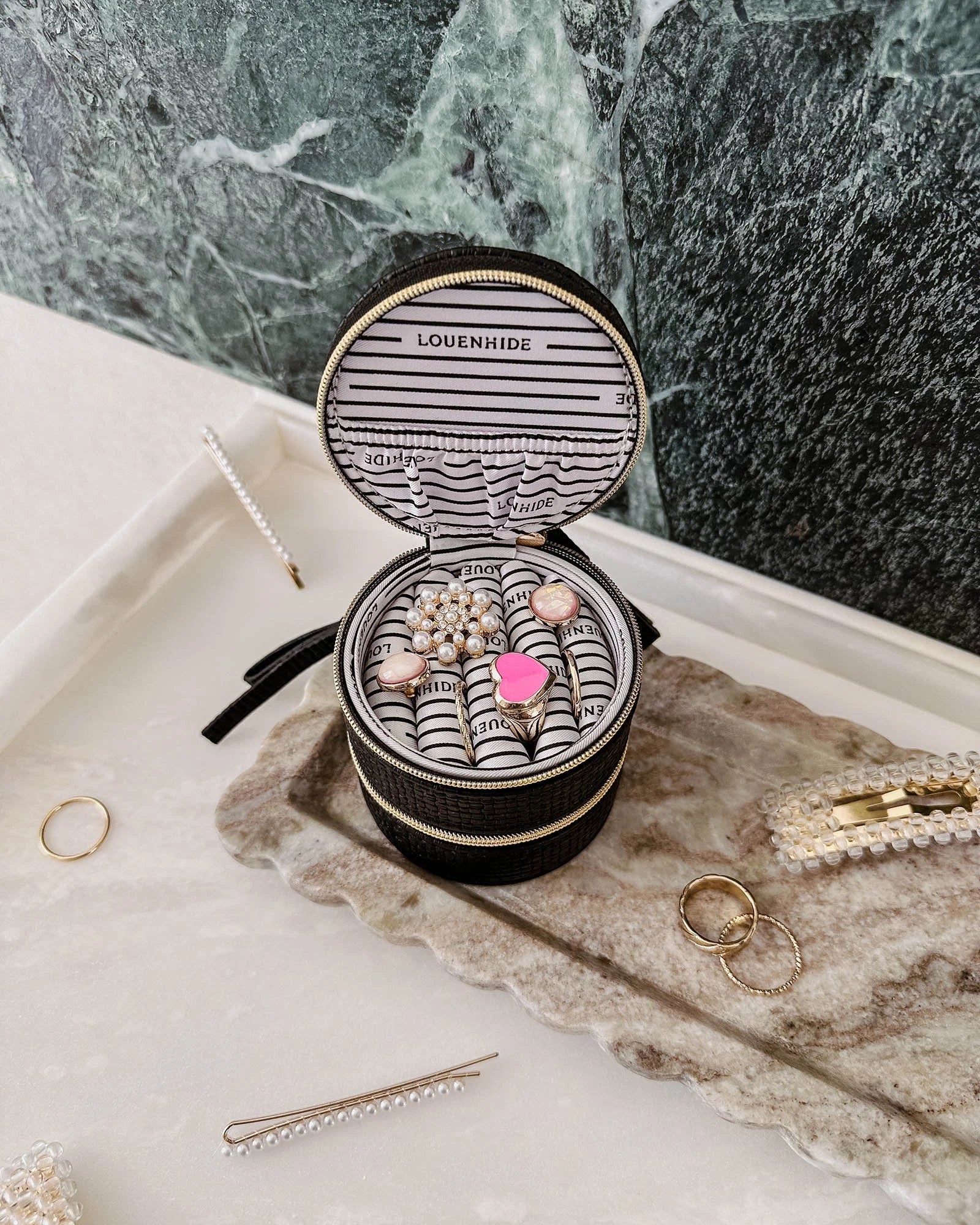 The Louenhide Sofia Jewelry Box is designed to hold and protect your most treasured pieces. Featuring a compact silhouette with two protective compartments, this multi-zipper case offers a streamlined way to store your jewellery without taking up unnecessary space. This travel jewellery case is the perfect addition to your bag, ensuring valuables stay secure and organised wherever the day leads.